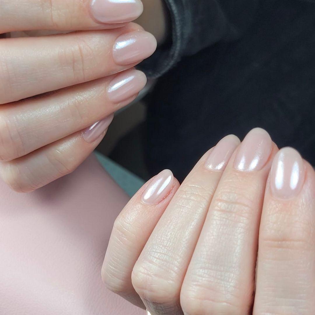 Almond-shaped BIAB manicure with a soft pink pearl chrome finish, part of our nail enhancement services in Grimsby.