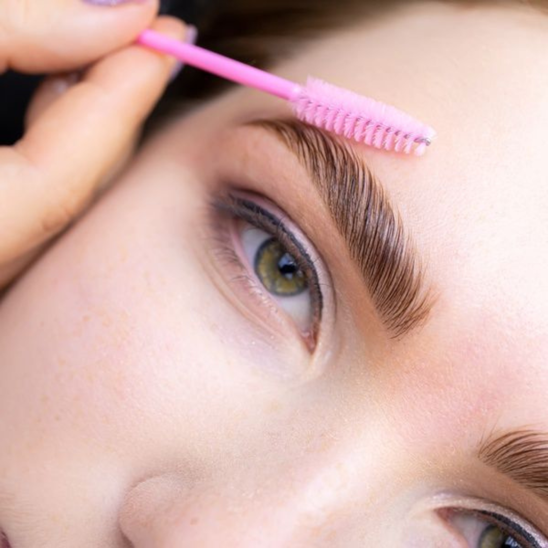 Close-up of eyebrow lamination, featuring perfectly brushed and styled brows with a smooth, lifted appearance.