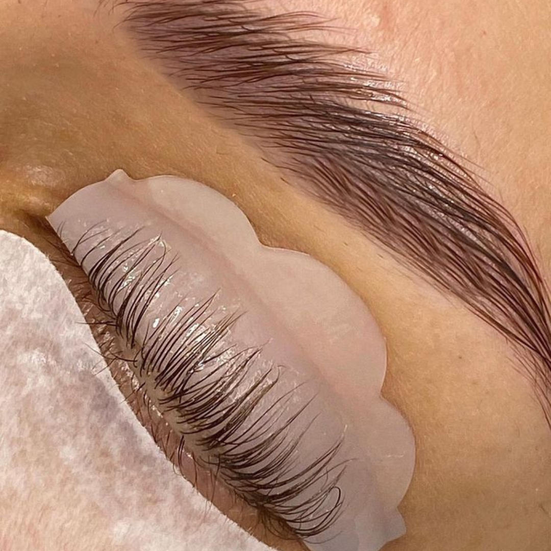 Close-up of a lash lift treatment, highlighting curled, lifted lashes alongside naturally styled brows for a polished, eye-enhancing look.