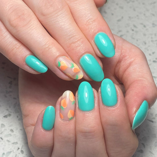 Vibrant turquoise gel polish manicure with almond-shaped nails and accent floral nail art featuring soft orange petals on a sheer base.